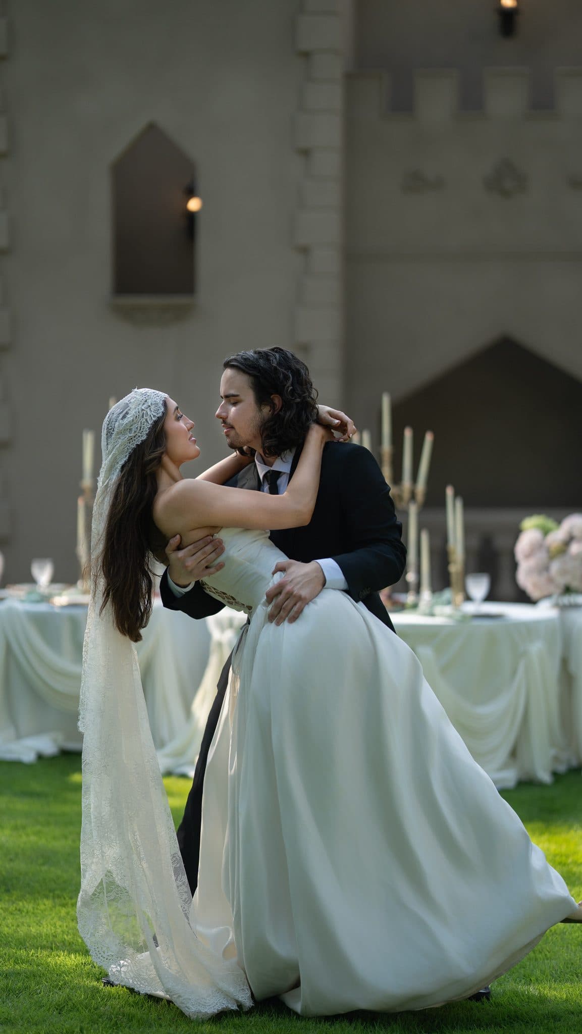 Bride and groom dip beneath the drape at The Castle at WildWood
