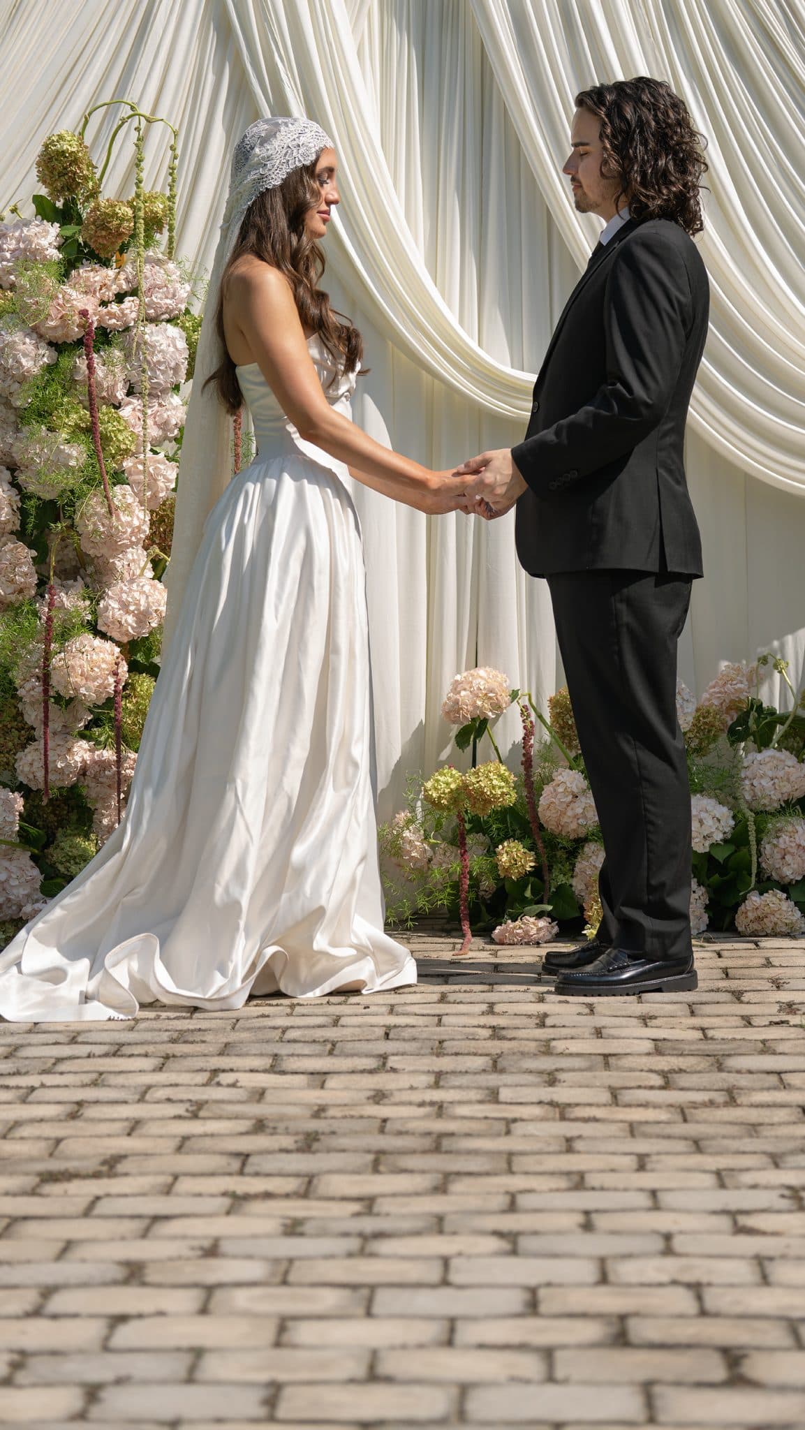 Couple beneath the ivory drape arch at The Castle at WildWood